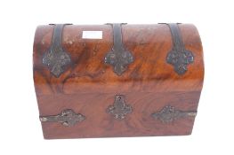 A Victorian brass bound dome top stationery box. Having red satin fabric and fruitwood interior.