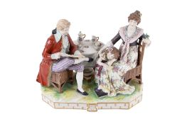 Capidimonte porcelain figure group 'Tea Party'. In the form of a gentleman reading to his family.