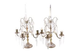A pair of Victorian brass and crystal three branch candlesticks. Raised on circular fluted bases.