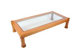 A contemporary glass top coffee table.