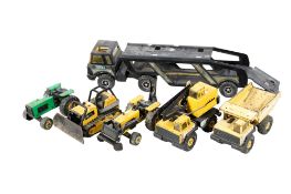 A collection of assorted vintage Tonka toy vehicles. Including car transporter, etc. Max.
