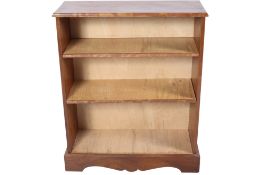 A freestanding mahogany open bookcase. Having two adjustable shelves raised on a plinth base.
