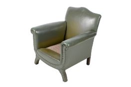 A first half of the 20th century green leatherette armchair (af).