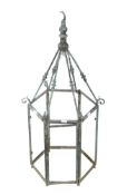 A verdigris metal hall pendant lantern frame. Of hexagonal form with a door.