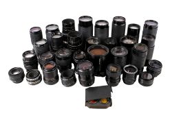 A collection of assorted vintage SLR camera lenses.