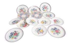 A collection of fourteen mid-century Poole Pottery plates. Max.