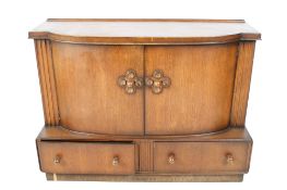 Early 50s deco style oak veneered sideboard. Having two curved doors over two drawers.