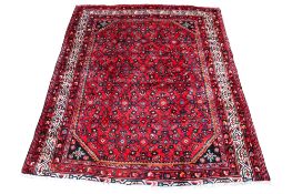 A red ground rug, handmade in Tabriz.
