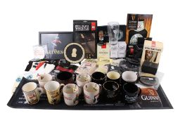 A group of asorted Guinness collectables in two boxes. Including socks and Pocket Pundit, etc.