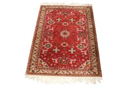 Persian style wool rug on a red ground (af).