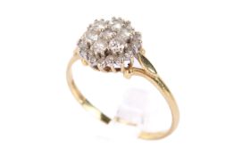 An 18ct gold and diamond cluster ring. Of flower form with small diamonds, hallmarked to shank.