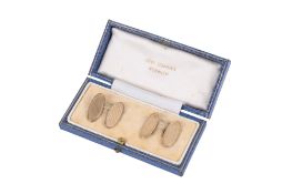 A pair of 9ct gold cufflinks. With machine turned decoration to the oval , marked 9ct.