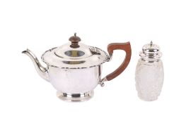 A 1930s silver teapot and a sugar caster.