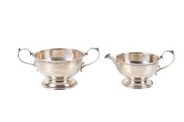 A George VI silver twin handled sugar bowl and jug.