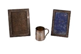 A George III silver christening cup and two later silver photograph frames.