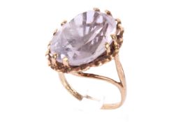 A hallmarked 9ct gold single stone ring. Set with a large pale lilac oval cut amethyst of 16.