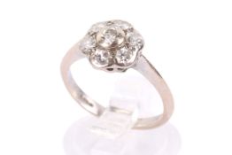 An 18ct gold and diamond cluster ring. Set with seven small diamonds of circa 2.