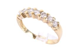 A yellow metal half eternity ring.