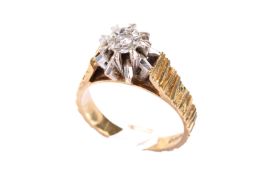 An 18ct gold and diamond dress ring. The illusion set diamond circa 2.