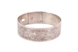 An engraved silver belt bangle.