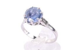 A sapphire and diamond three stone ring.