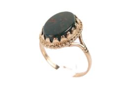 A 9ct gold and bloodstone ring. The oval of circa 1.4cm x 0.