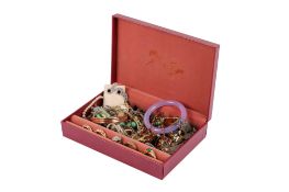 A red jewellery box of mixed costume jewellery.