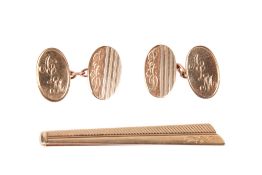 A 9ct gold tie clasp and a pair of 9ct gold cufflinks.