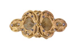 A two-part gold plated belt buckle.