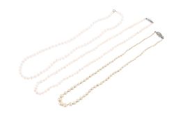 Two pearl necklaces and one faux pearl example.