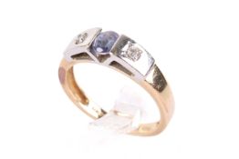A yellow metal and tanzanite ring.