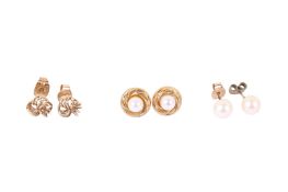 Three pairs of stud earrings.