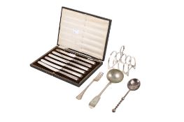 A small group of silver and white metal table items.