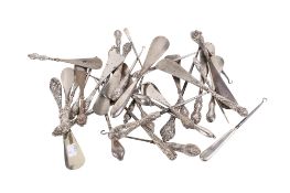 A collection of repousse silver handled shoehorns and boot hooks. Various patterns, some hallmarked.