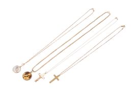 Four 9ct gold and yellow metal crucifixes and photograph pendants on gold and yellow metal chains.