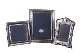 Three silver photograph frames.