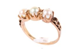 A yellow metal and pearl ring.