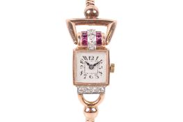 A yellow metal diamond and ruby dress watch.