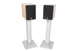 A pair of Q Acoustics bi-wired audio speakers. Model 1020i on stands.