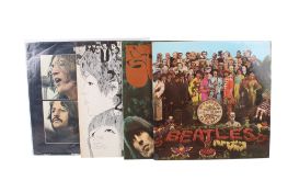 A group of four Beatles LP vinyl album records.