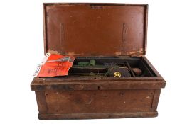 A collection of vintage Meccano parts and pieces in an old wooden tool box.