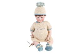 An early 20th century German Bisque head doll by Jutta 1914.