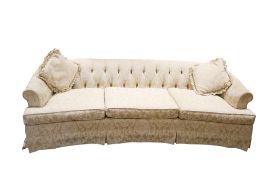 A vintage three seater button back curved sofa.