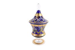 A Bohemian cobalt blue glass and enamel urn and cover. Decorated with wreaths and portraits.