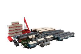 An assortment of 00 gauge carriages and rolling stock.