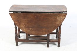 An antique oak gateleg dining table.