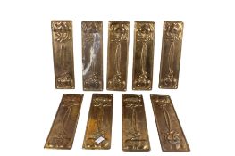 A group of nine 'Art Nouveau' style pressed metal door finger plates. Floral design 8.5cm x 28.