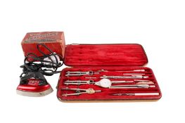 A vintage draughtsman's cased drawing set and a travel iron.