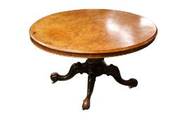 A Victorian walnut veneer oval tilt top table (in two parts, no fixings).