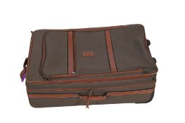 A large Longchamp canvas and leather trolley suitcase.